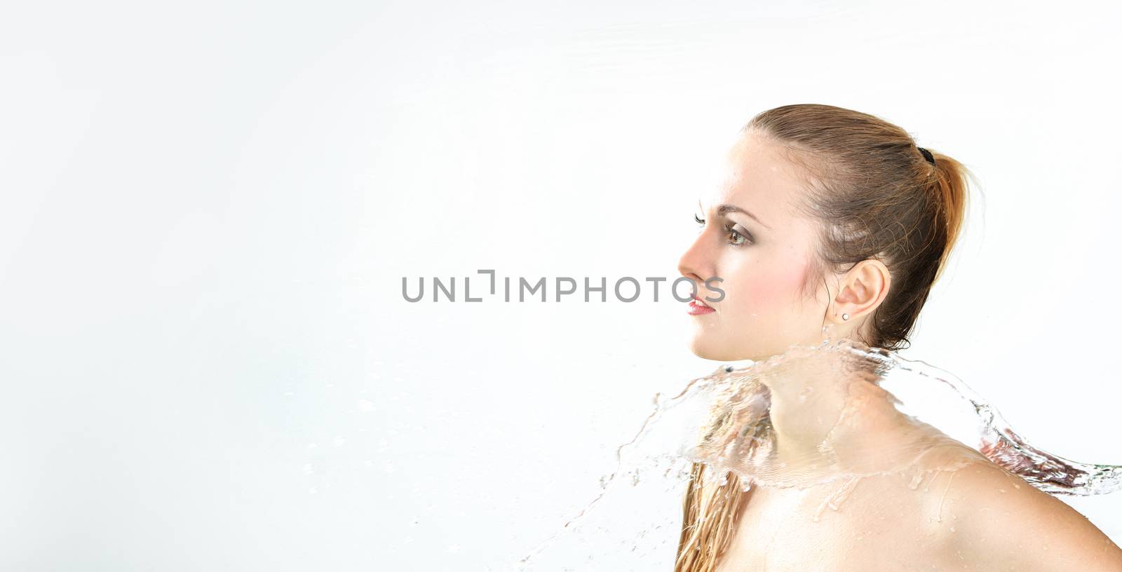 pretty woman with water splash. Beautiful model woman with a splash of water. Beautiful smiling girl underwater with fresh skin on blue background. Skin care, cleansing and moisturizing concept. Pretty face