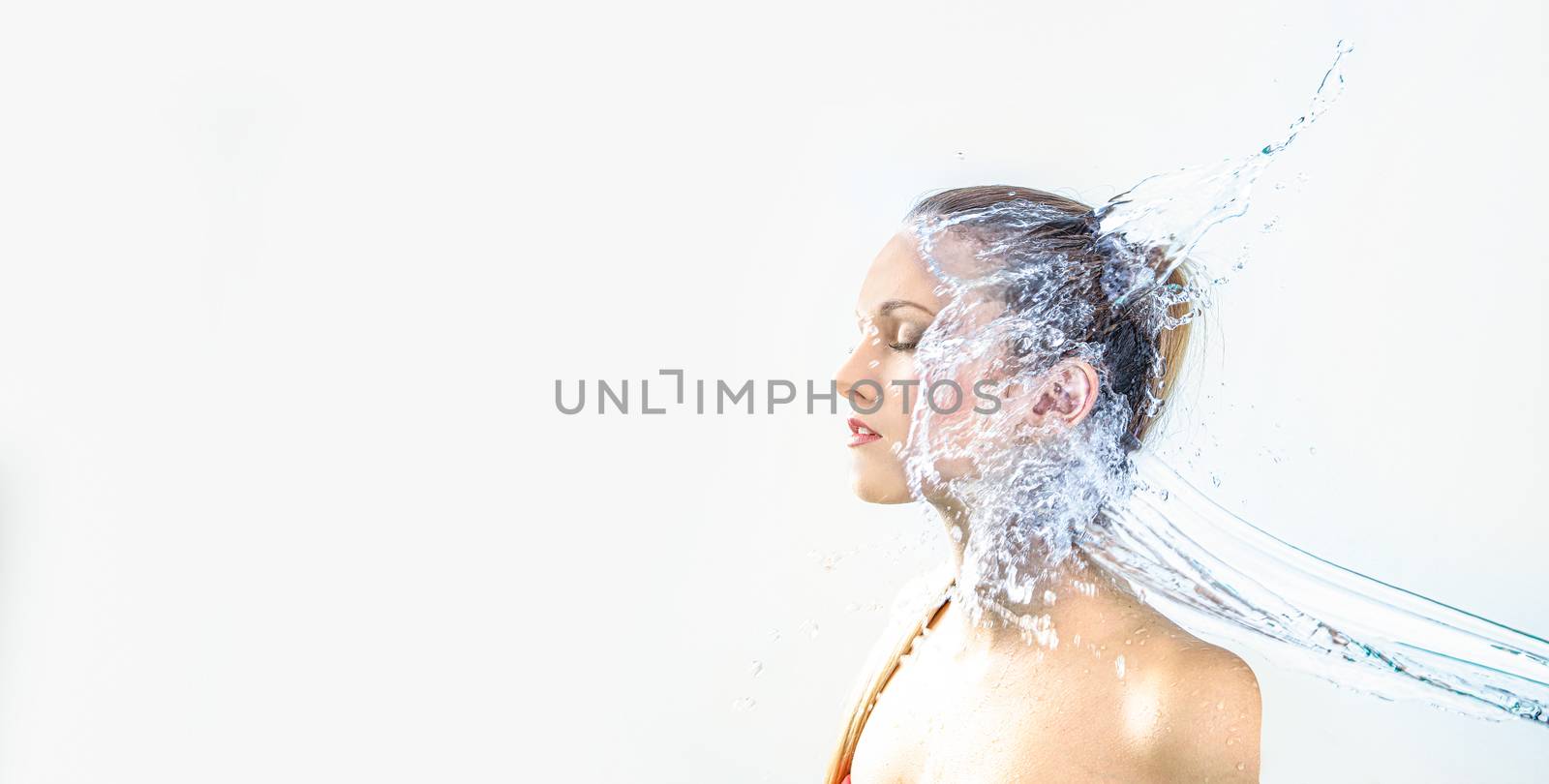 pretty woman with water splash. Copy space. Beautiful model by PeterHofstetter