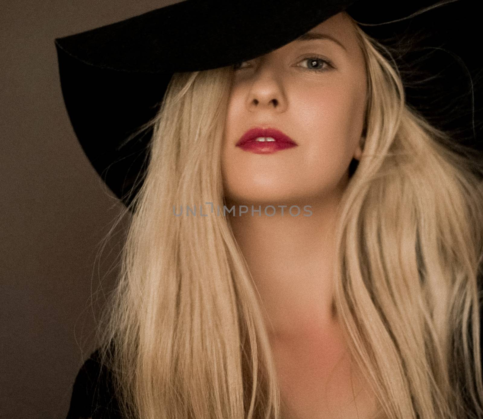 Classy blonde woman wearing a hat, artistic film portrait for fa by Anneleven