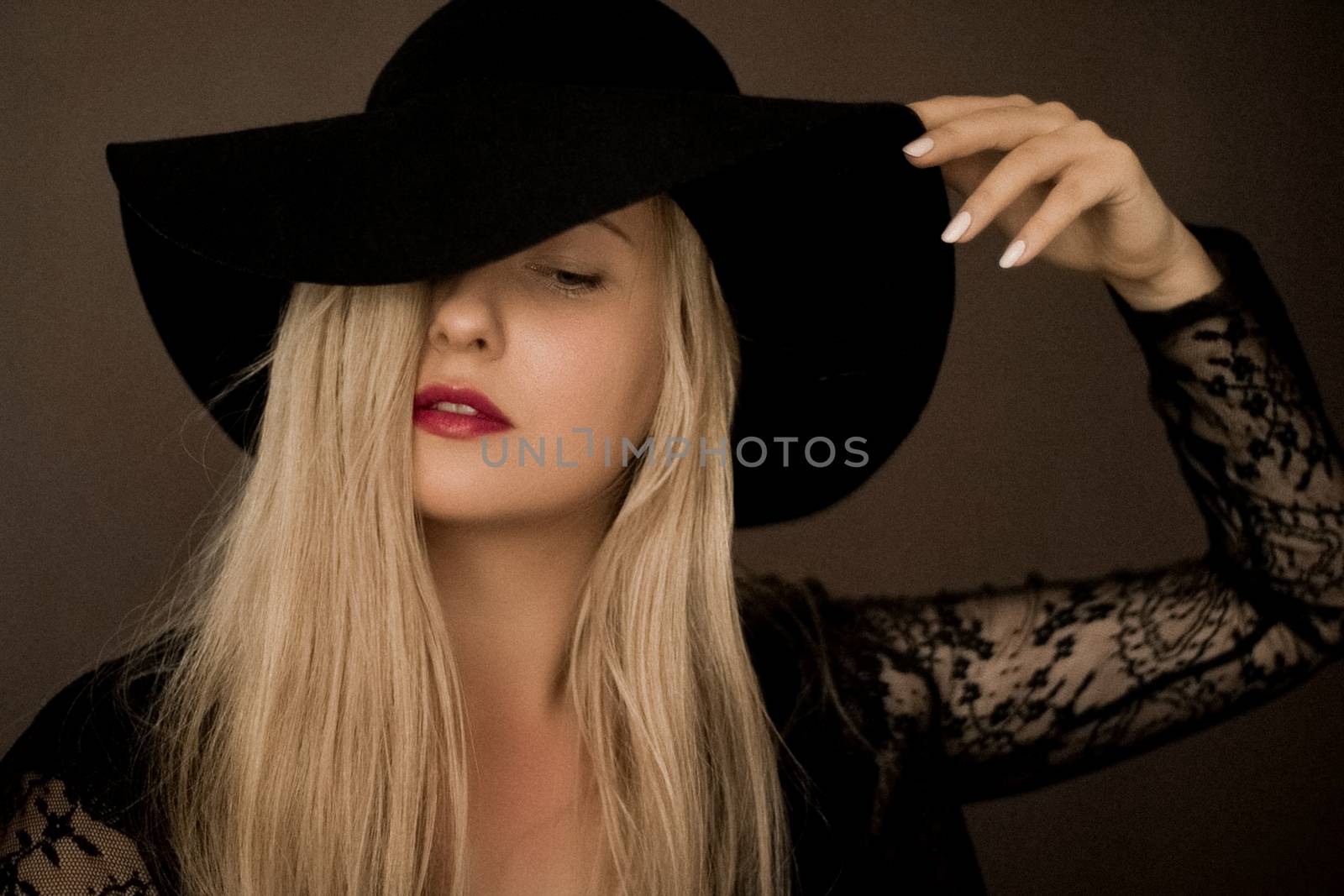 Classy blonde woman wearing a hat, artistic film portrait for fa by Anneleven
