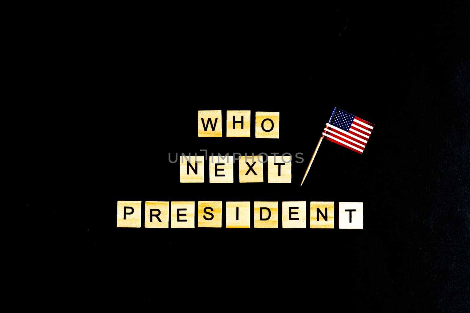 The phrase Who is the next American President - with an American flag in the background. A new election race in the United States. Primary. Candidates. Politics. Government. Force. flatlay, top view.