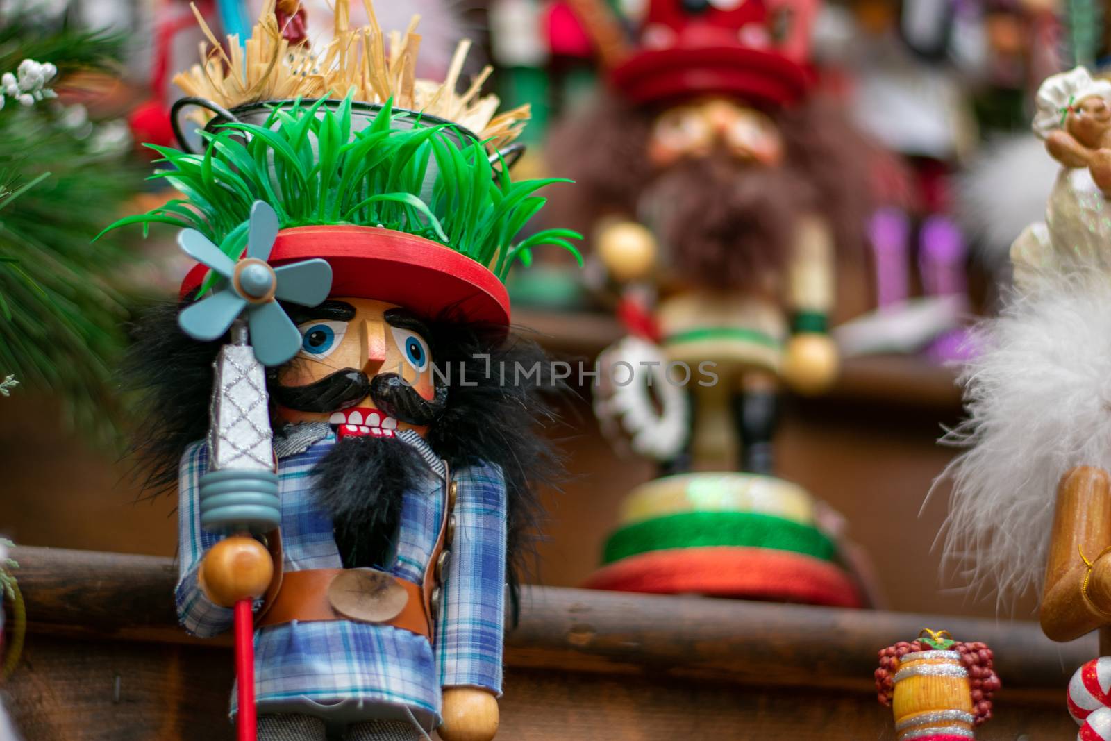 A Funny Looking Nutcracker on a Wooden Shelf With Other Nutcrack by bju12290