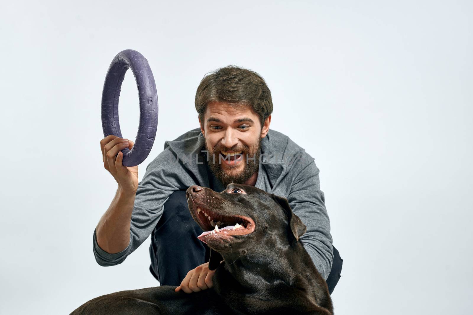 happy owner with pet black dog training model emotions. High quality photo