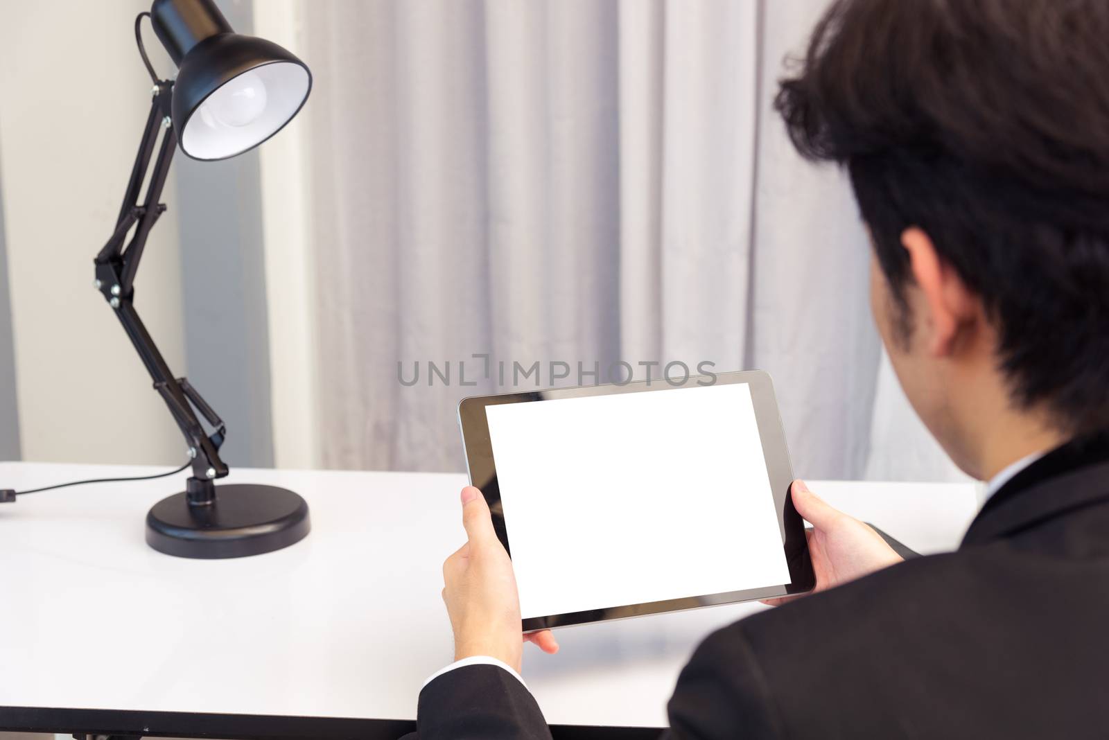 Back view of Businessman video conference by tablet by Sorapop