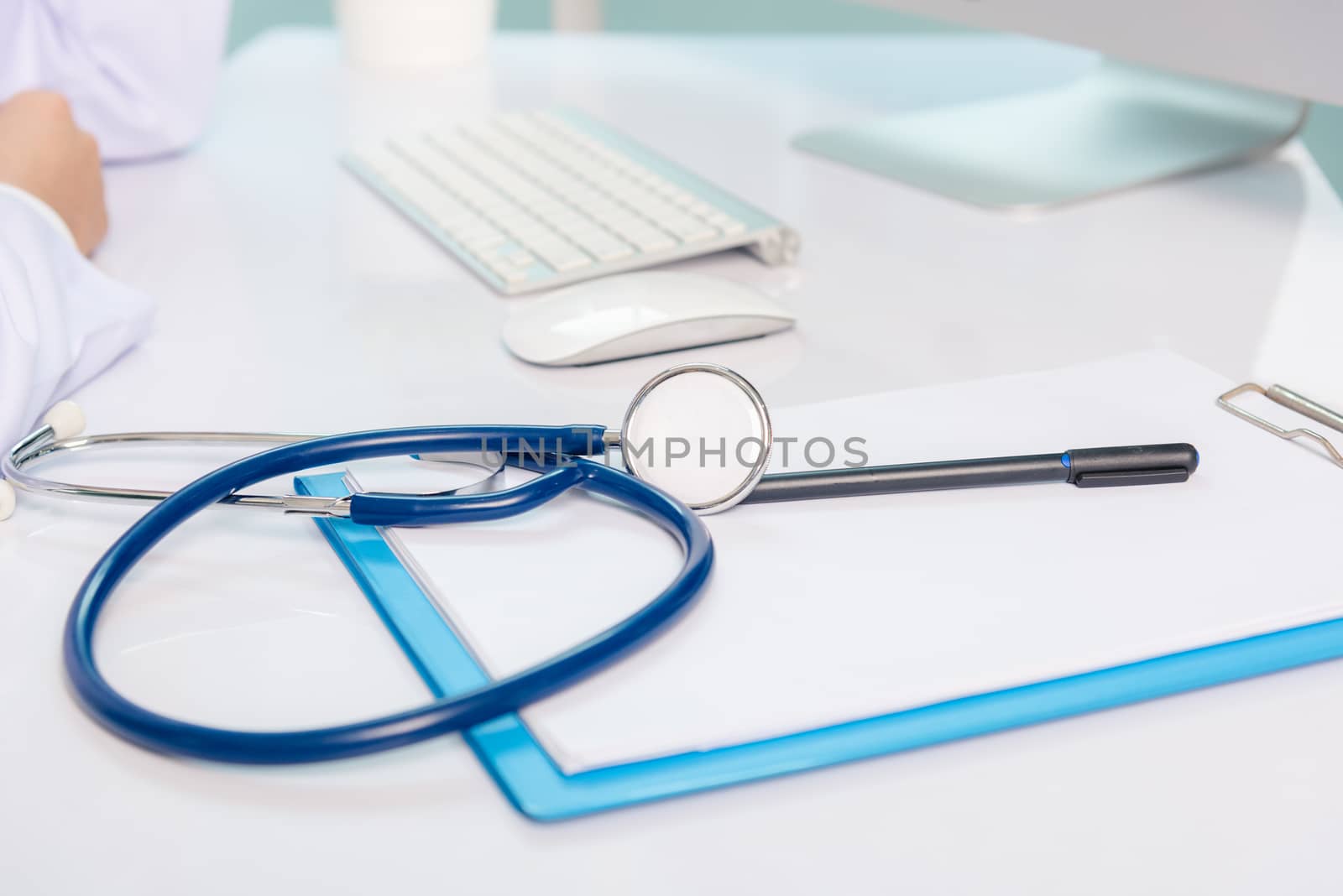 Medicine doctor's working on desk. Closeup of Stethoscope. Hand of man physician video call raise hands to greet patients on table front computer monitor at hospital office, Healthcare medic concept