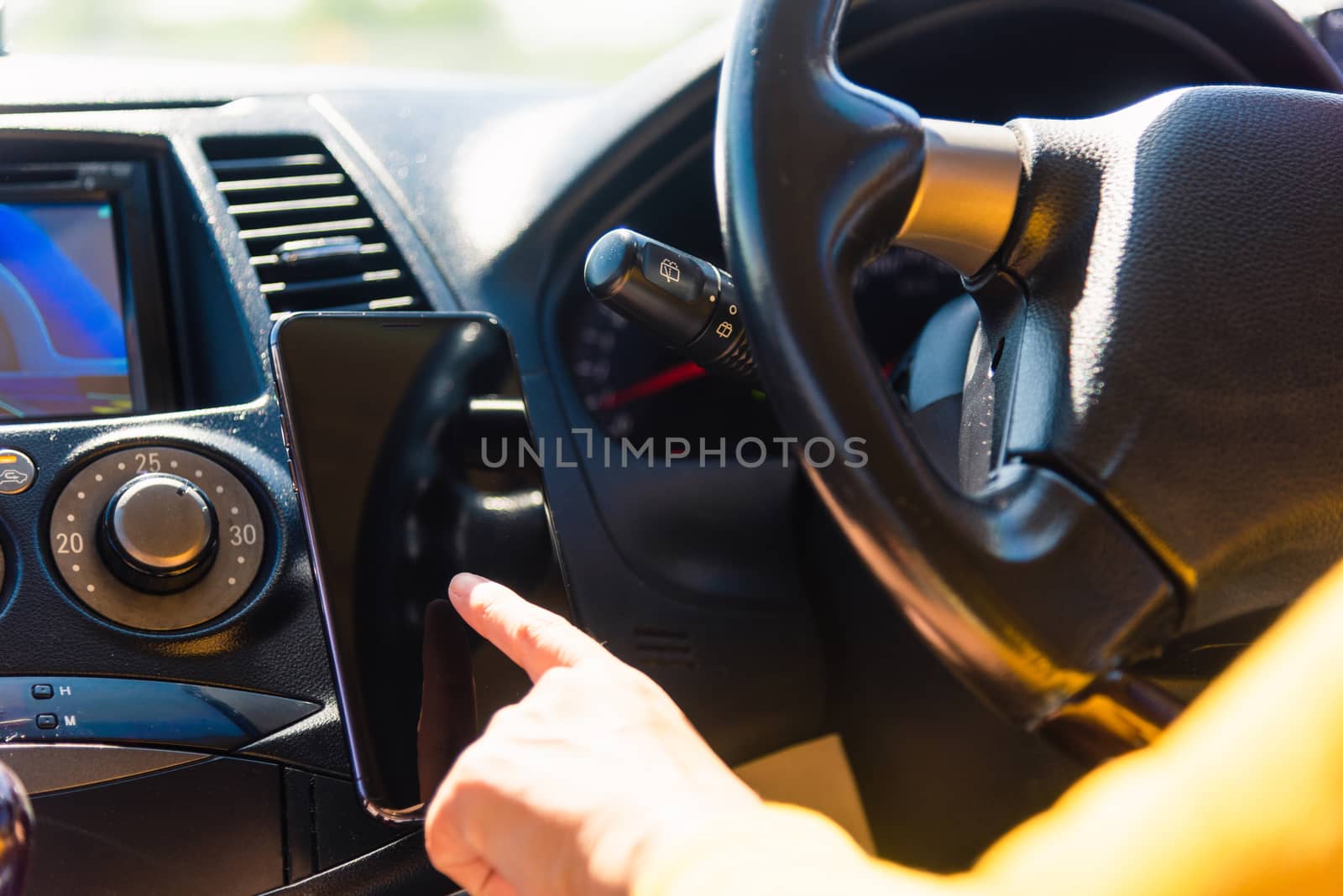 Asian woman inside a car and using touch screen on mobile smartphone blank screen while driving the car in the morning on highway she find navigation location to go Transportation and vehicle concept