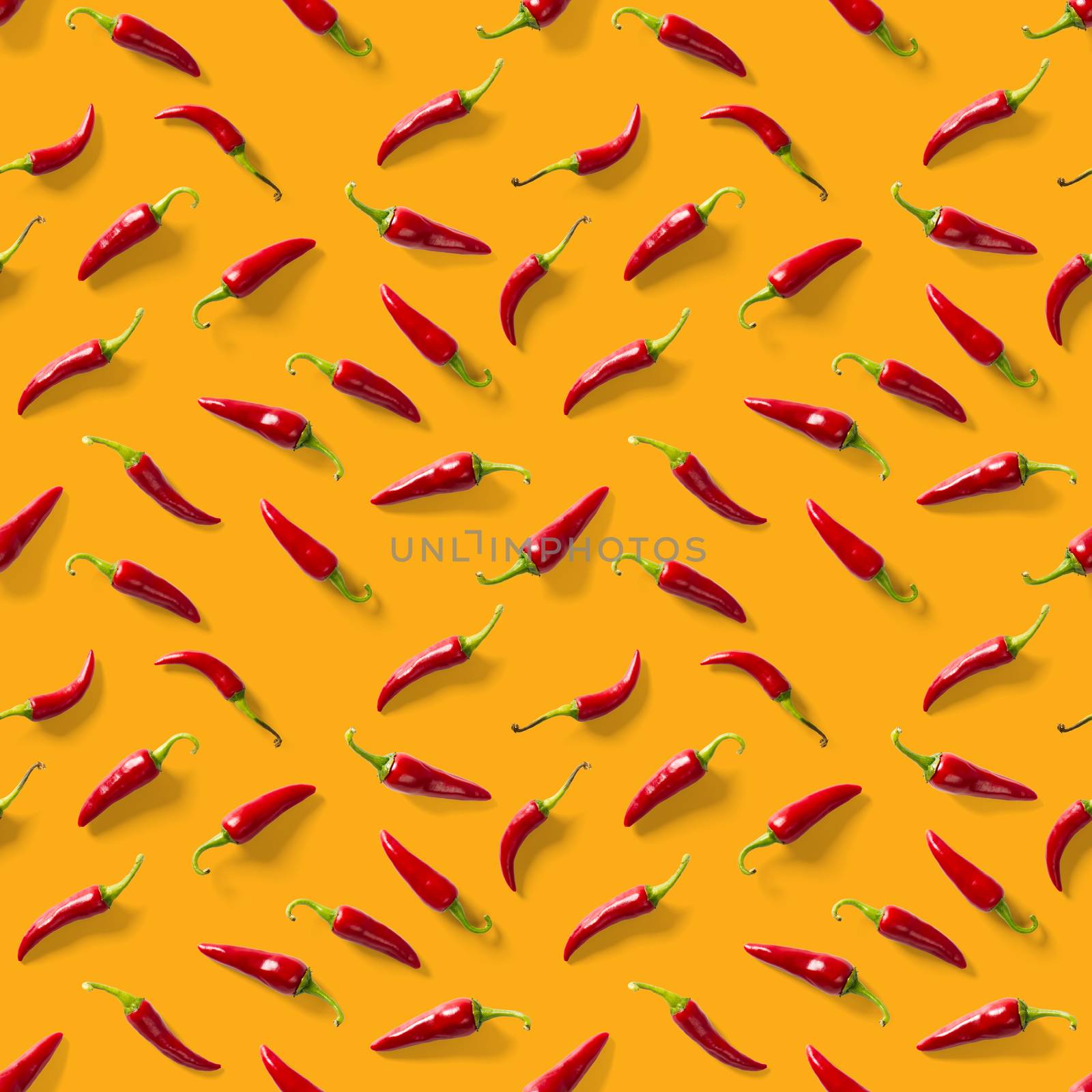 Red hot chilli seamless peppers pattern. Seamless pattern made of red chili or chilli on orange background. Minimal food pattern. Food background.