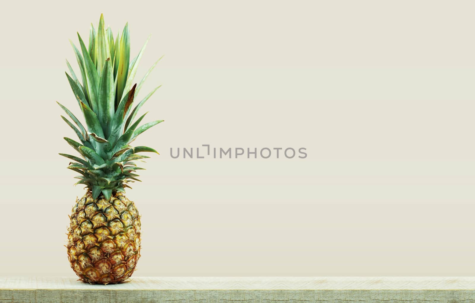 Pineapple on wooden with the white background.