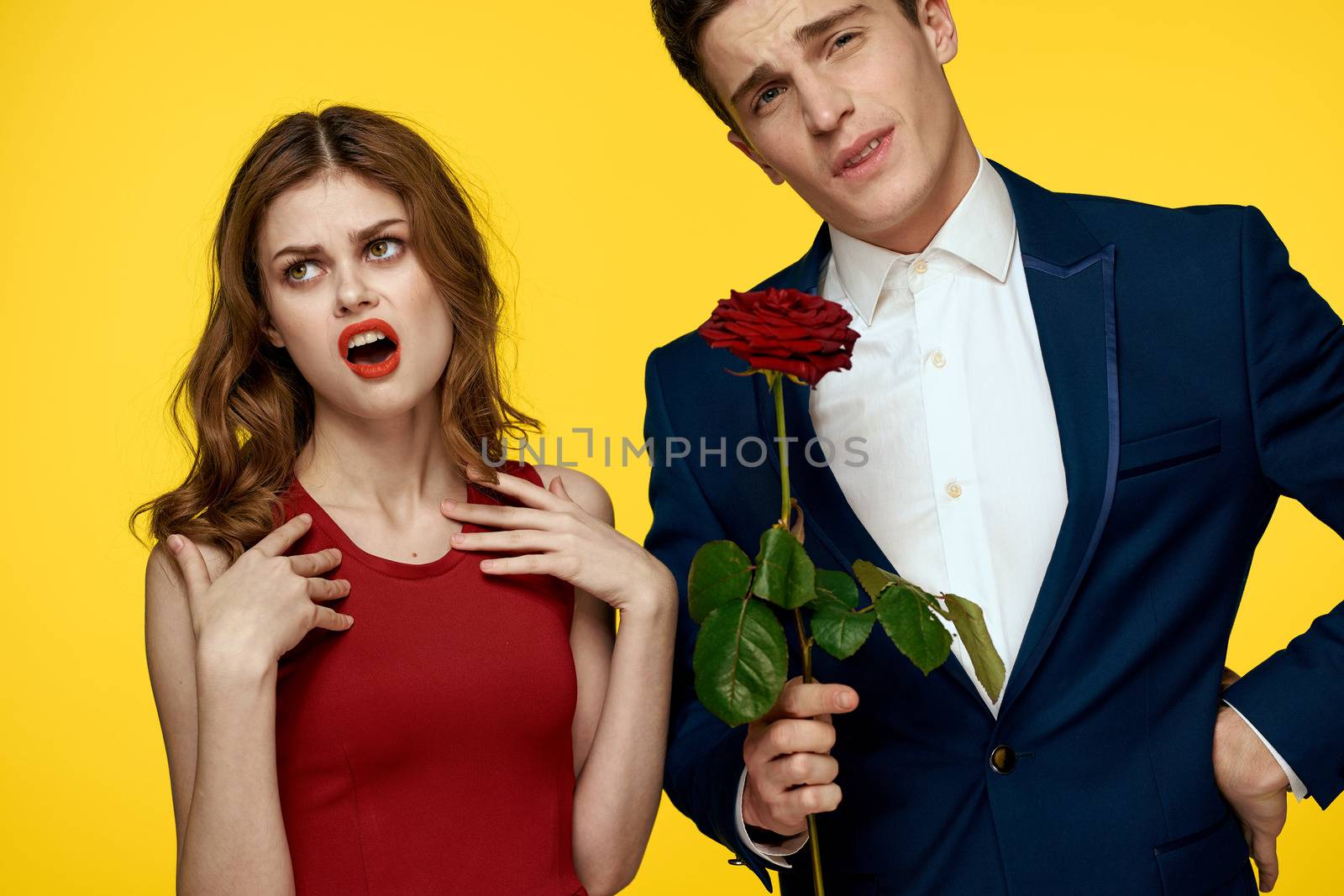 Young charming couple rose relationship romance gift as a lifestyle yellow isolated background. High quality photo