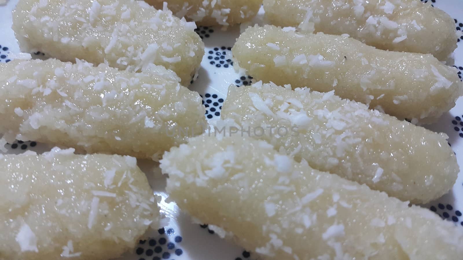 Traditional home made sweets cham cham or chum chum (selective focus ) served in a white ceramic plate