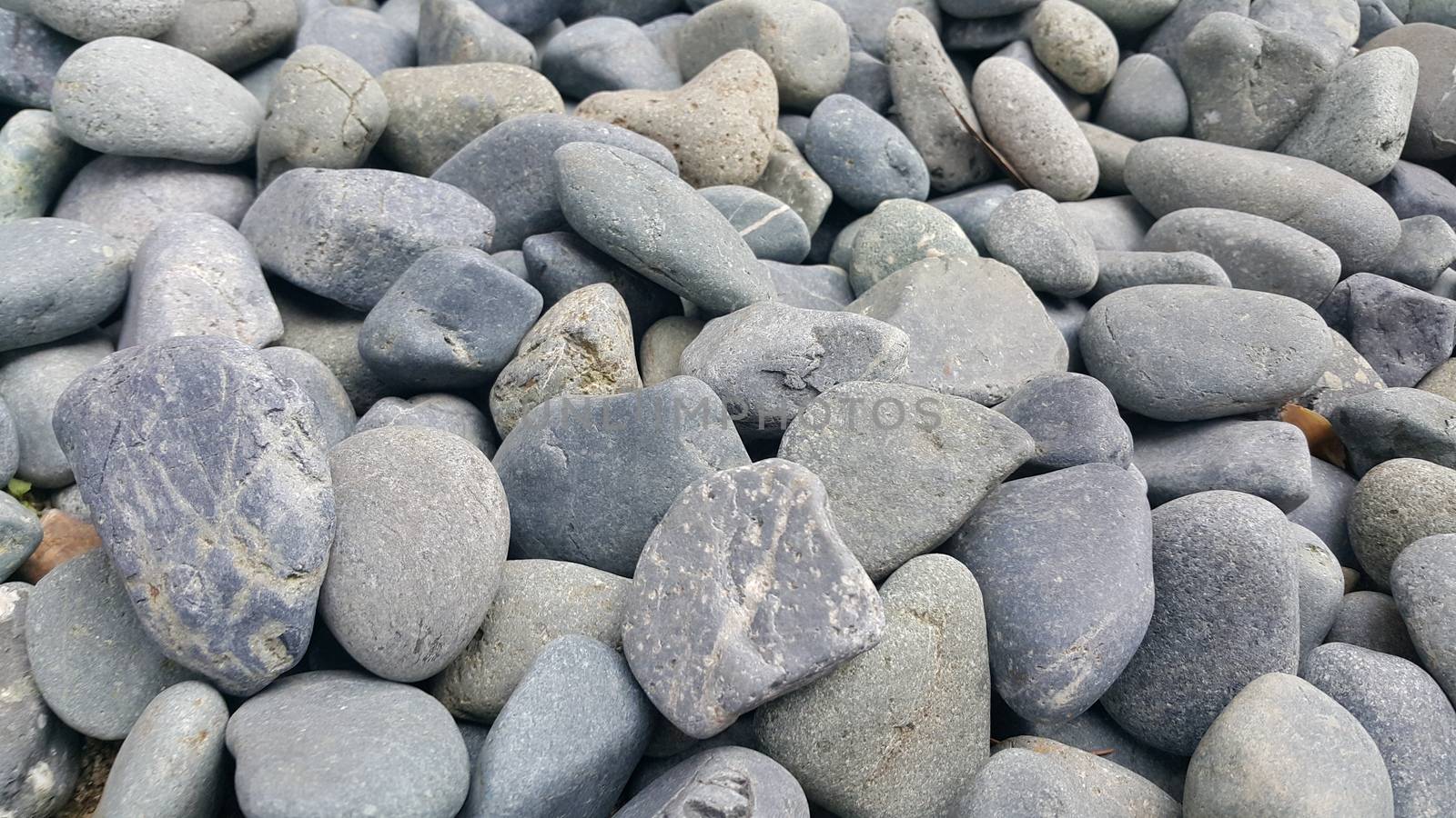 Texture background: Rock Pebbles, small, rounded, smooth pibbles with copy space for text