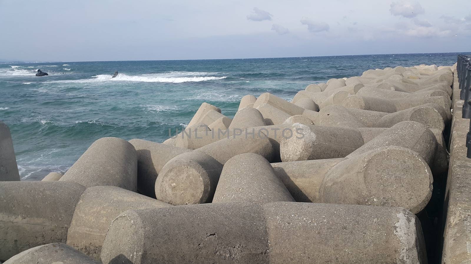 Close view of tetrapod stones on the sea shore to prevent coastal ersosion. Break water concrete tetrapods.