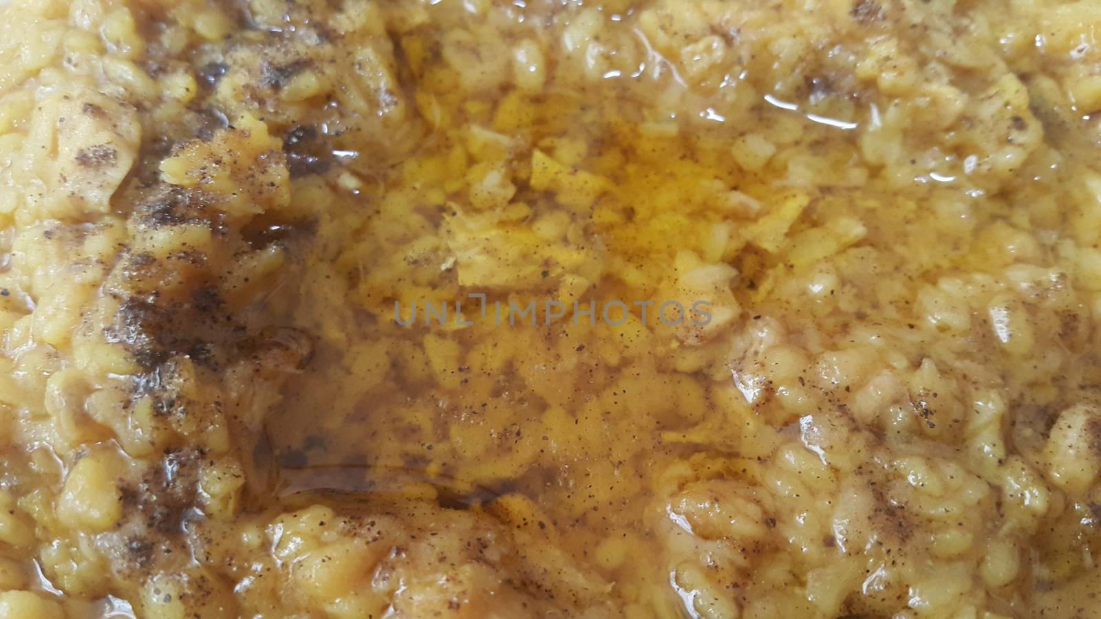 A close up view spicy daal dish served with ghee on it. Traditional Asian home made spicy lentil or daal dish
