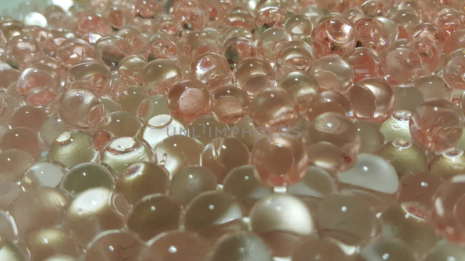 Closeup view with selective focus of shiny glittering orbeez or colorful water balls hydrogel. Water beads orbeez background.