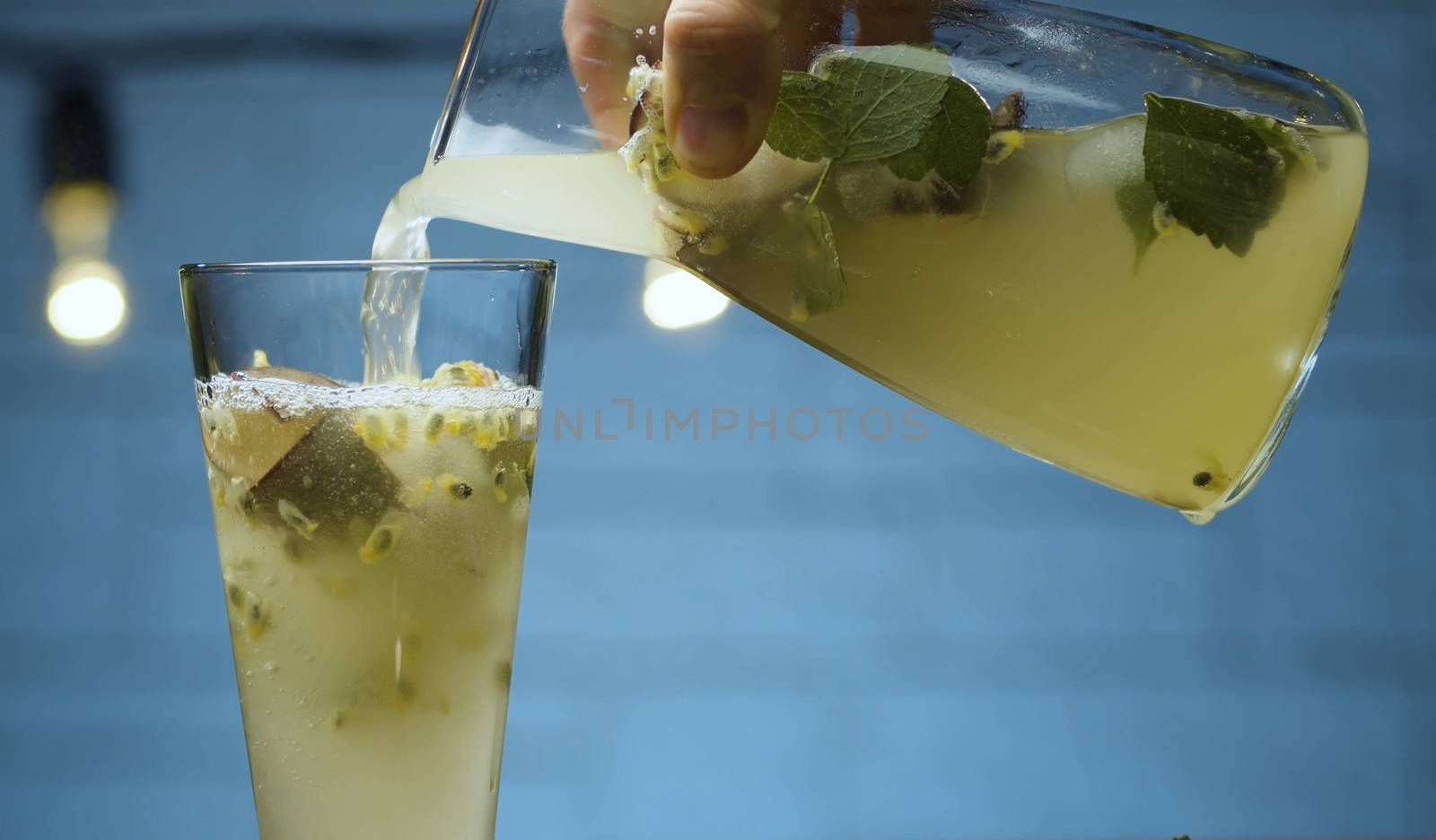 Pouring mint and passion fruit drink by Alize