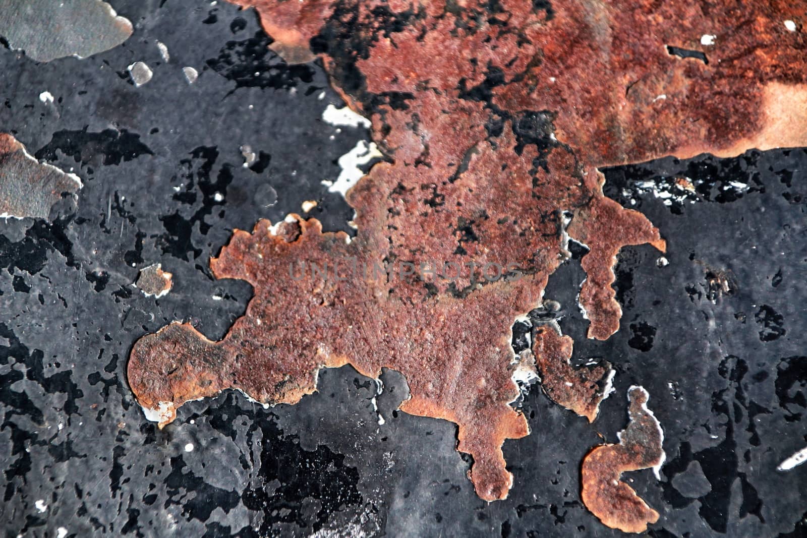 Colorful texture of old paint on rusty metal door