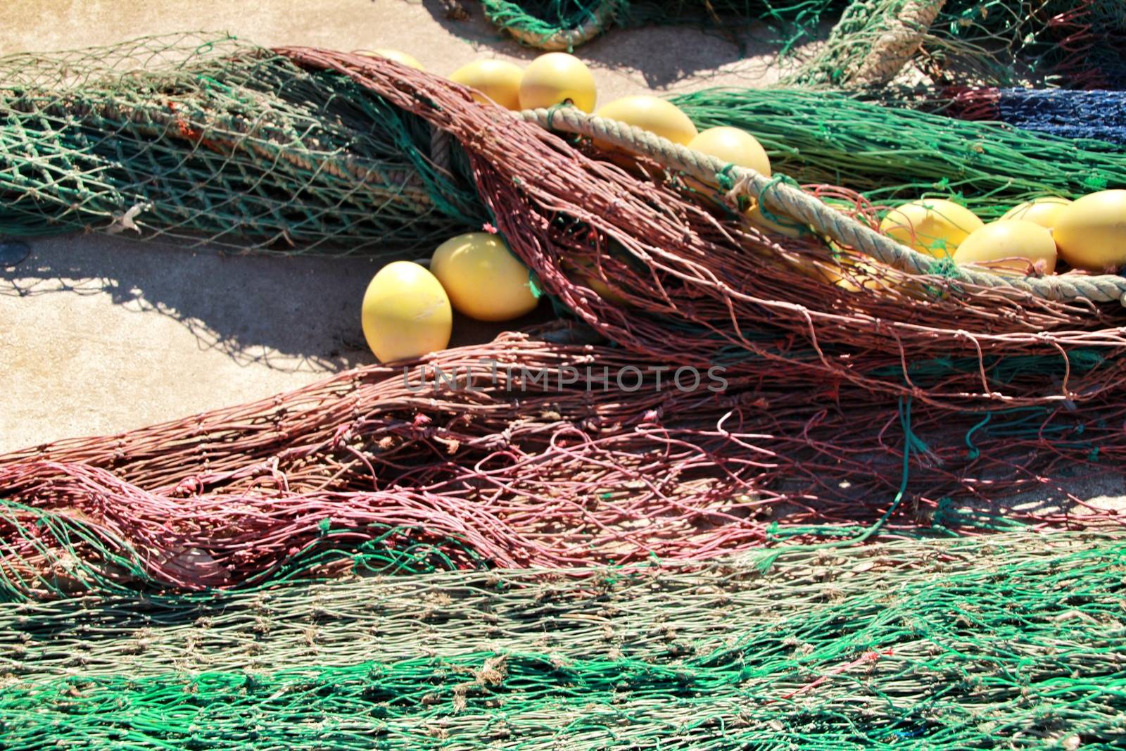 Fishing nets background and colorful buoys in the port of Santa Pola, Alicante