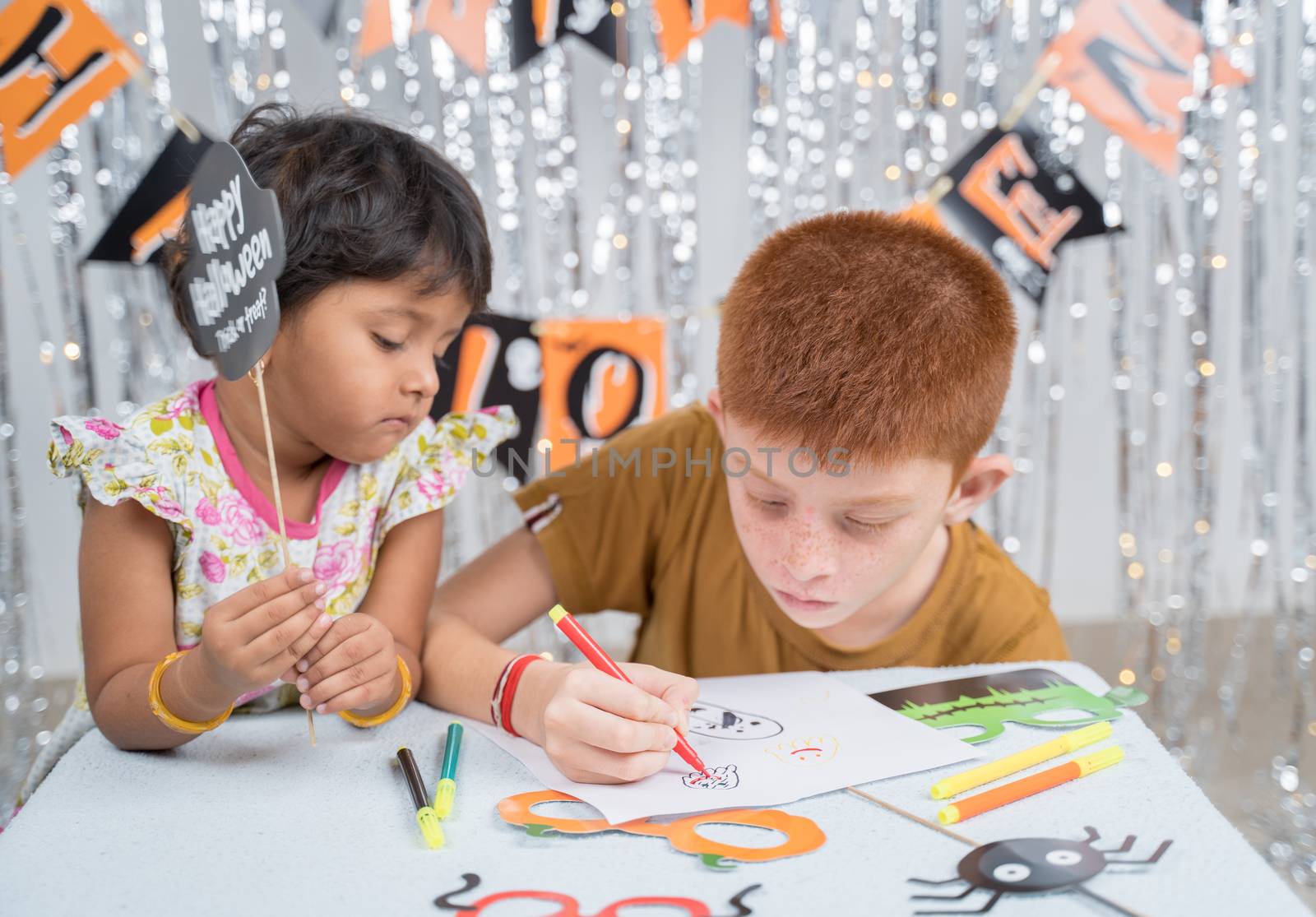 Selective focus on drawing hands, Kids busy in making or drawing halloween props - concept of halloween, holiday and childhood festival celebration and preparation