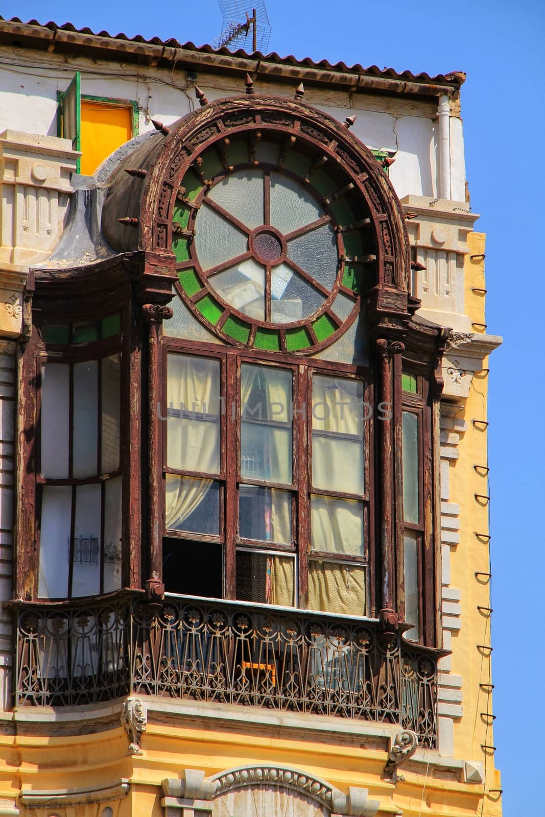 Old colorful and beautiful facade with wooden window in Cartagena street in Summer.