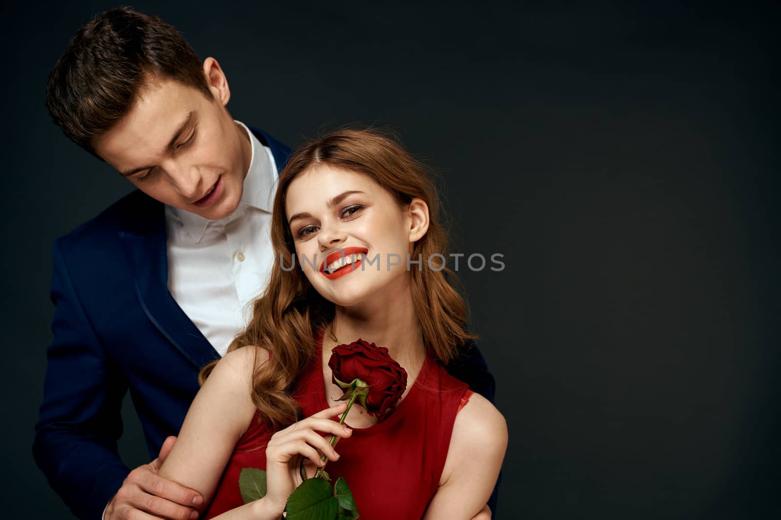 Beautiful couple charm hug lifestyle relationship rose luxury dark background. High quality photo