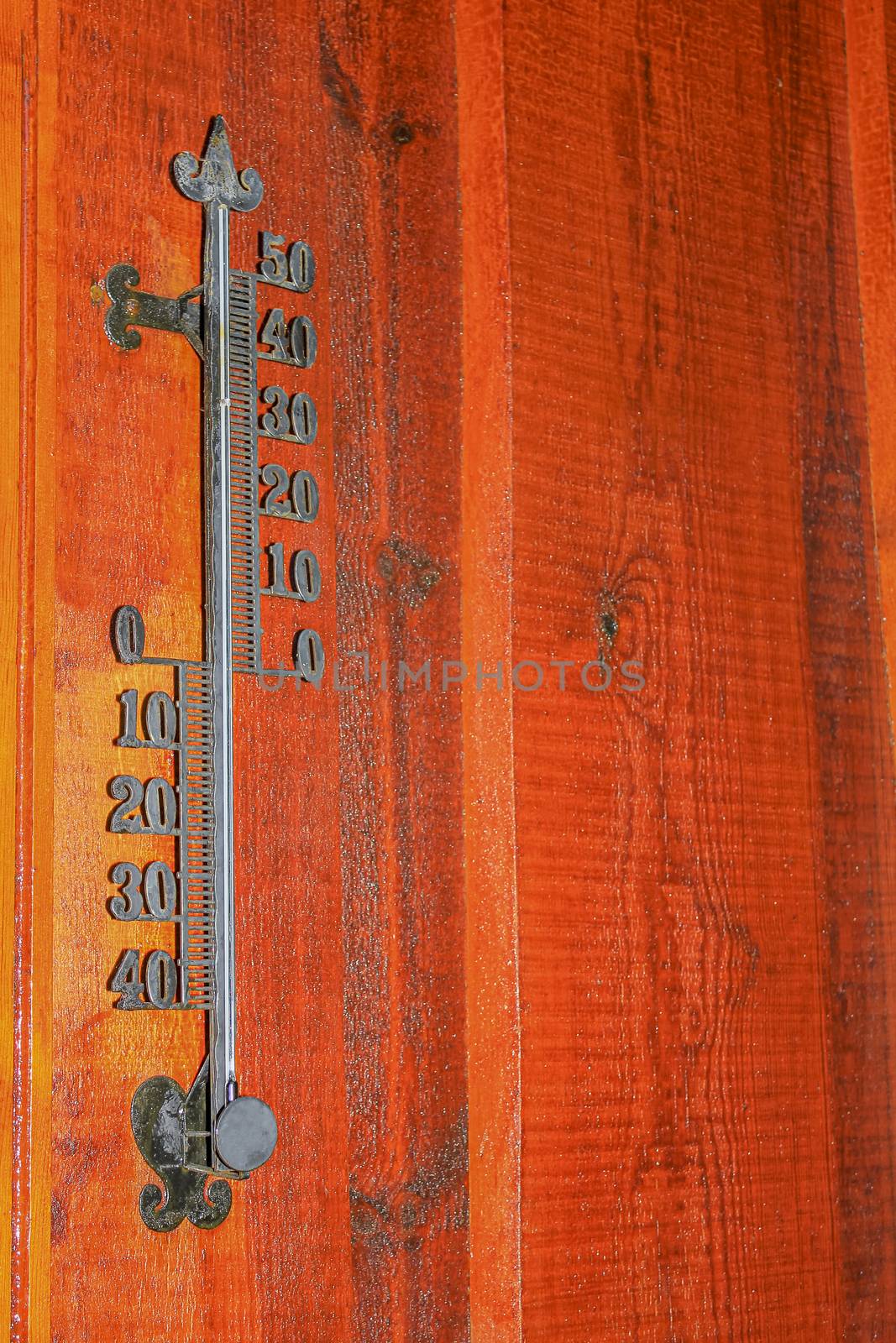 Temperature gauge on a wooden wall in Norway. by Arkadij