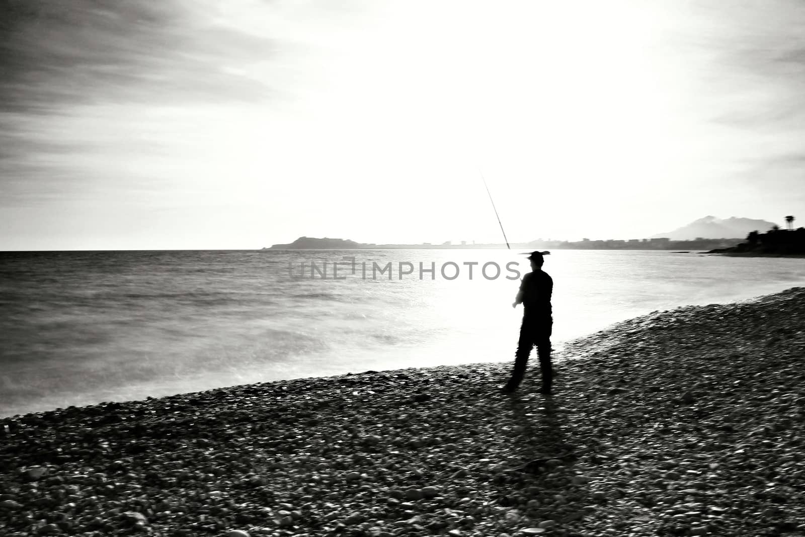 Fisherman in the evening on Mojon beach in Isla Plana, Cartagena, Murcia,Spain.
