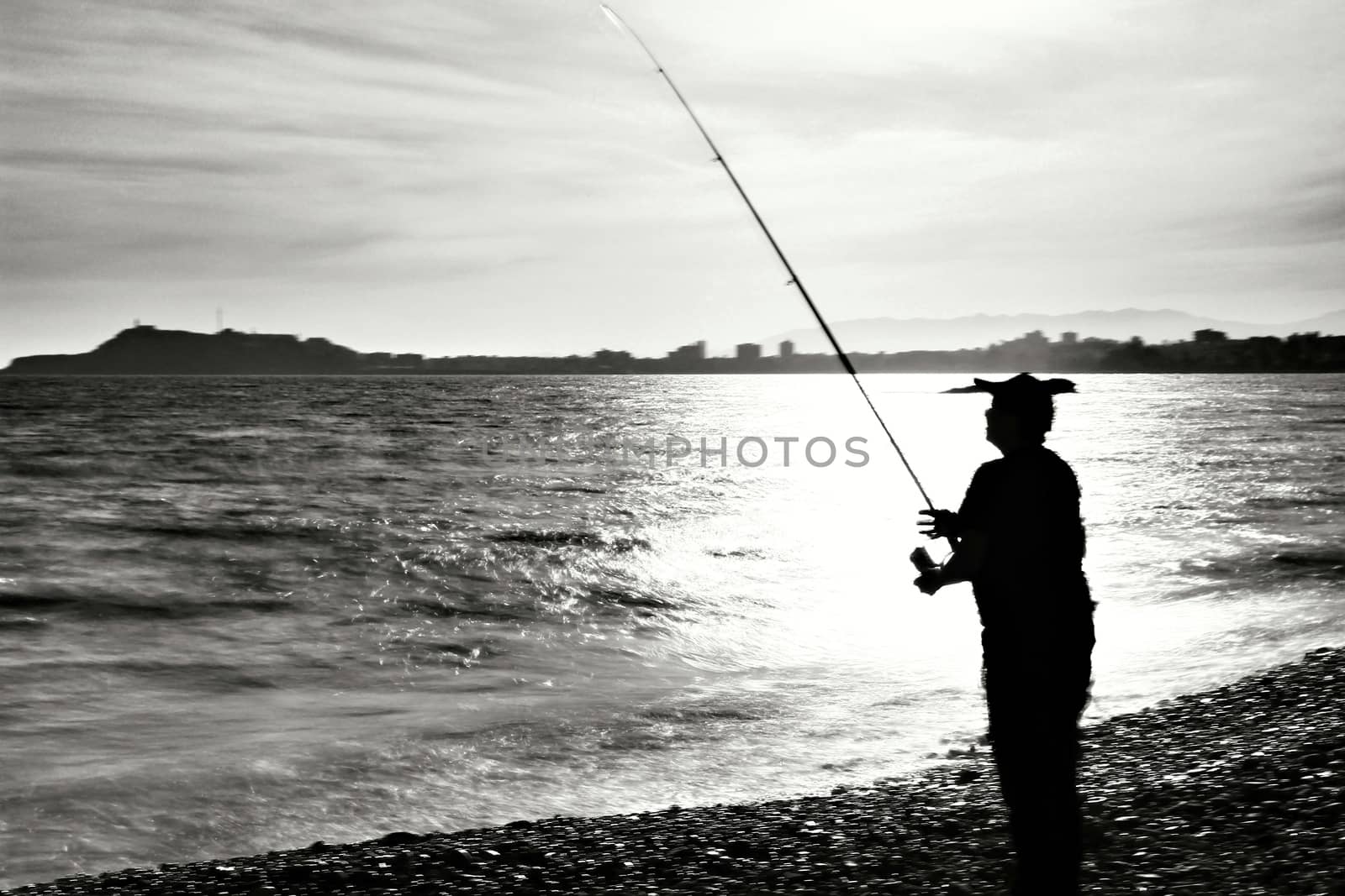 Fisherman in the evening on Mojon beach in Isla Plana, Cartagena, Murcia,Spain.