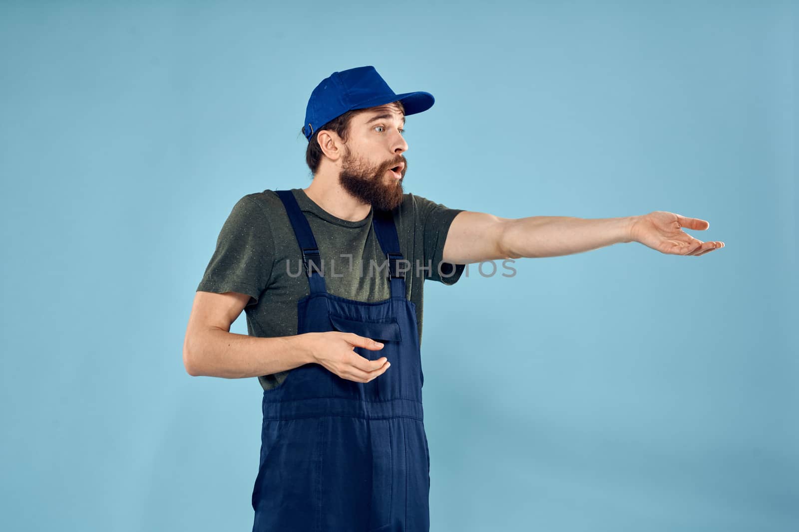 man in work uniform uniform professional work lifestyle delivery service blue background. High quality photo