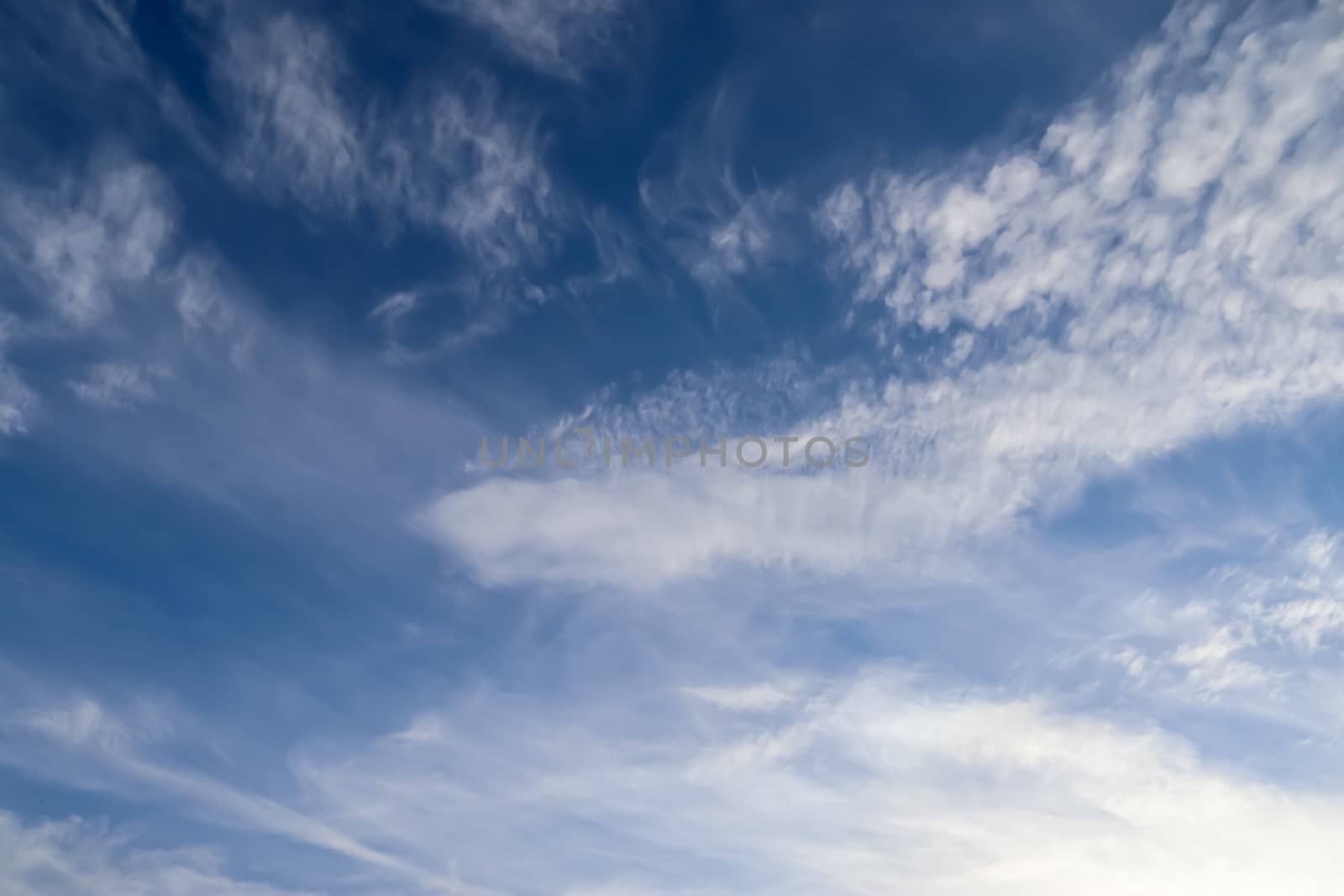 Stunning cirrus cloud formation panorama in a deep blue summer sky seen over Europe