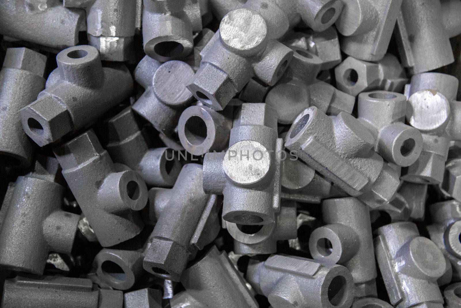abstract industrial full frame close-up background of gray steel castings storage pile