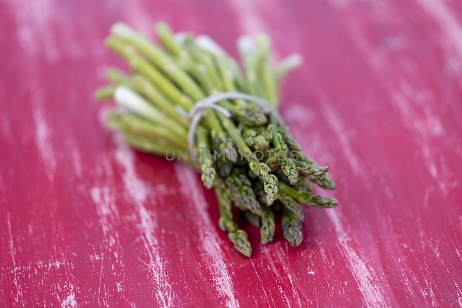 green asparagus on a red table