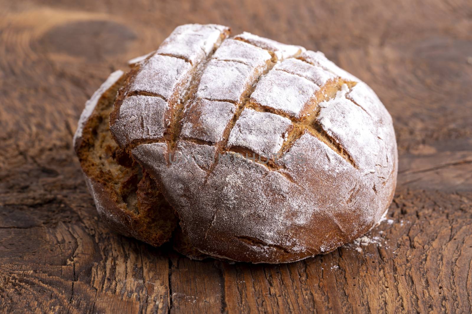 fresh rye bread on dark wood