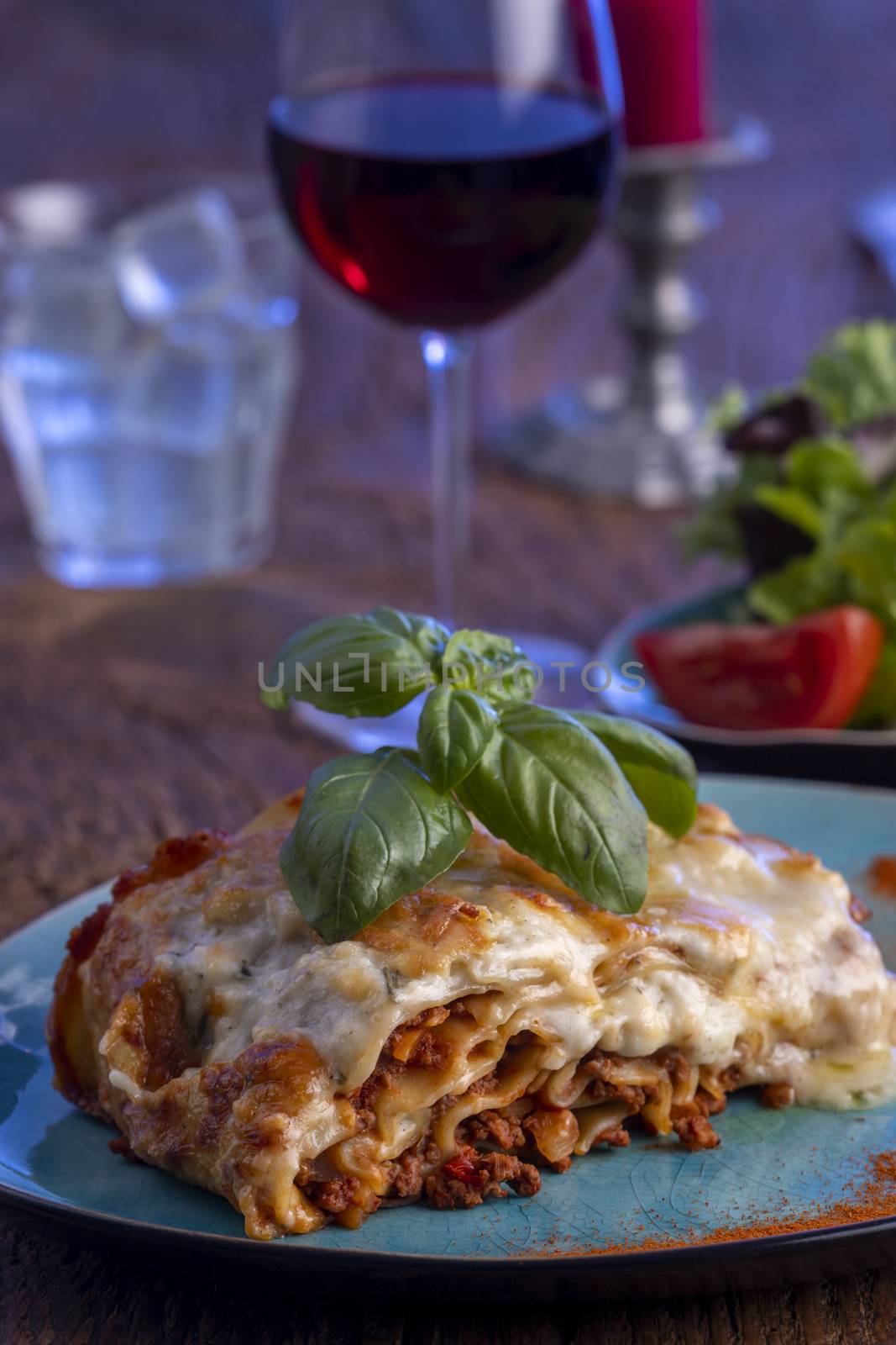 fresh lasagna on a blue plate
