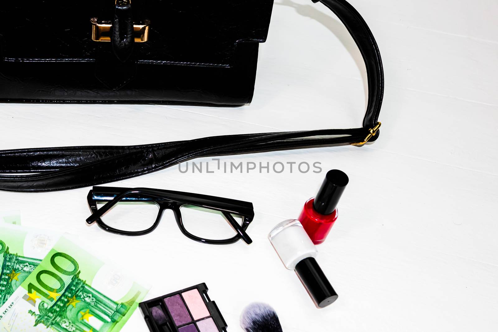 Elegant purse with money and cosmetics beauty products isolated  by vladispas