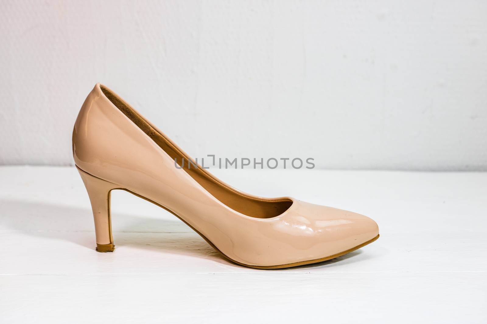 Beige high heels shoes isolated on white background with copy space.