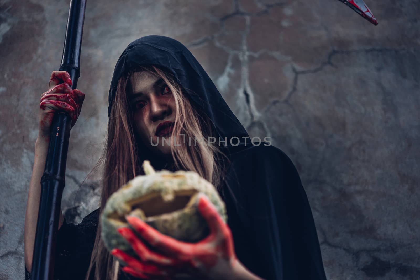 Woman ghost horror holding pumpkin her have blood on hand, halloween day concept