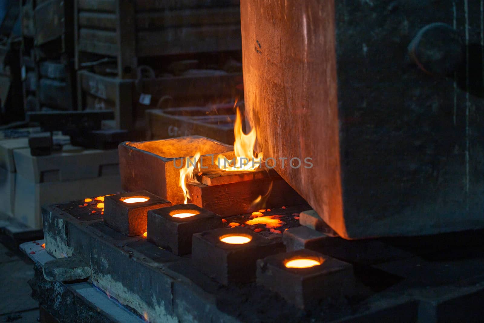 the chill mold cools down after pouring liquid steel - close-up with selective focus and background blur