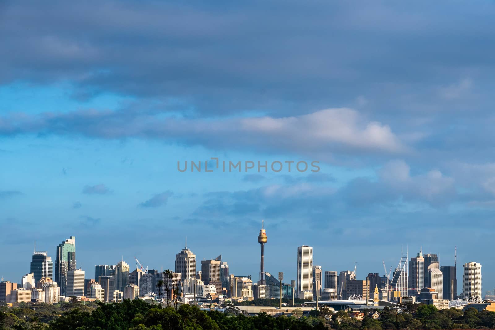 Sydney CBD skyline captured from the south in a partially cloudy morning.
