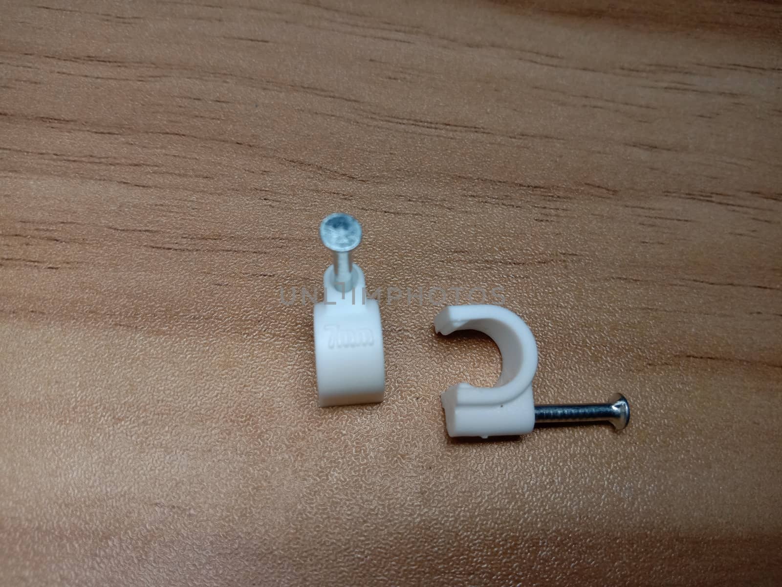 white colored wire pin on wooden table