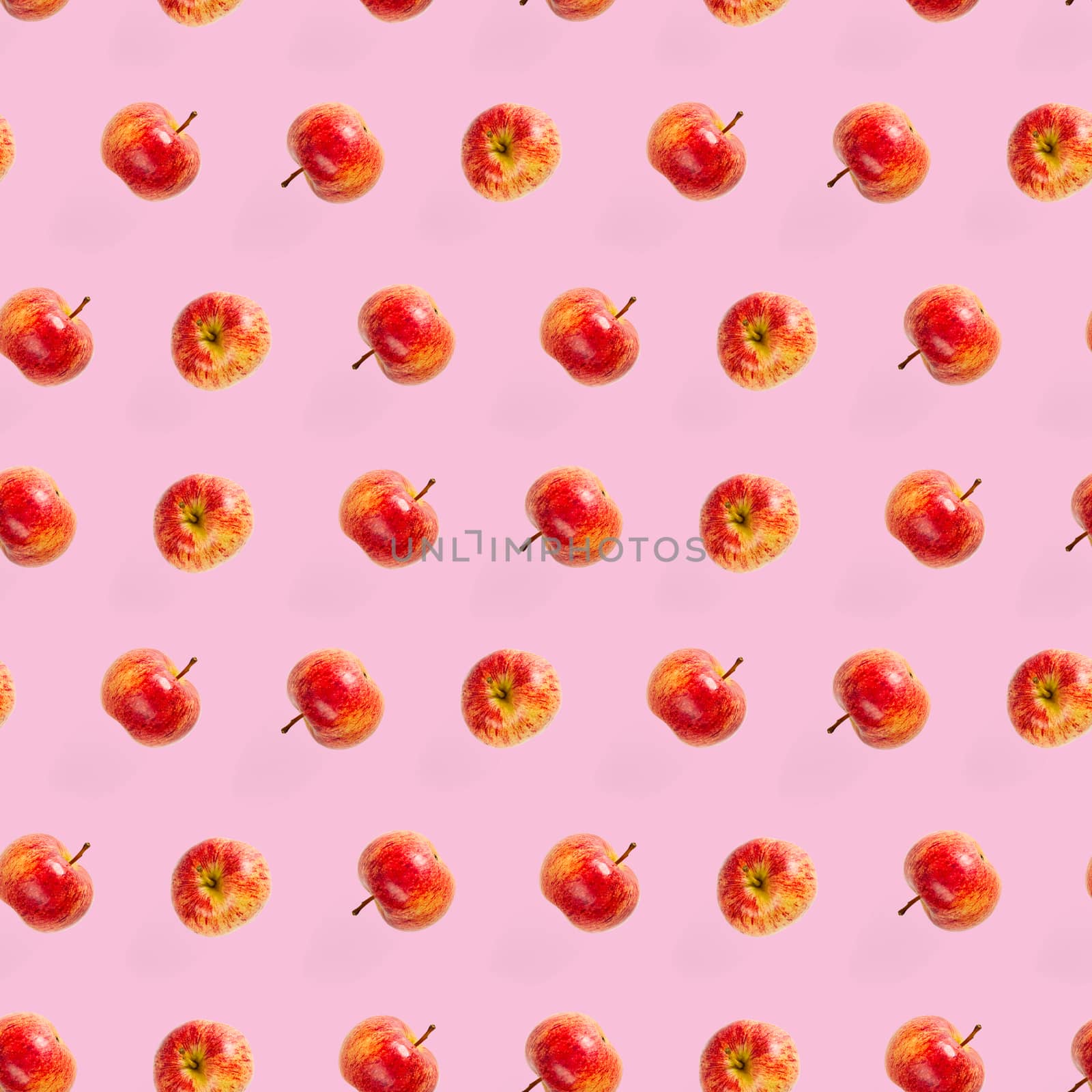 Seamless pattern with ripe apples. Apple seamless pattern on pink background. Tropical fruit abstract background.