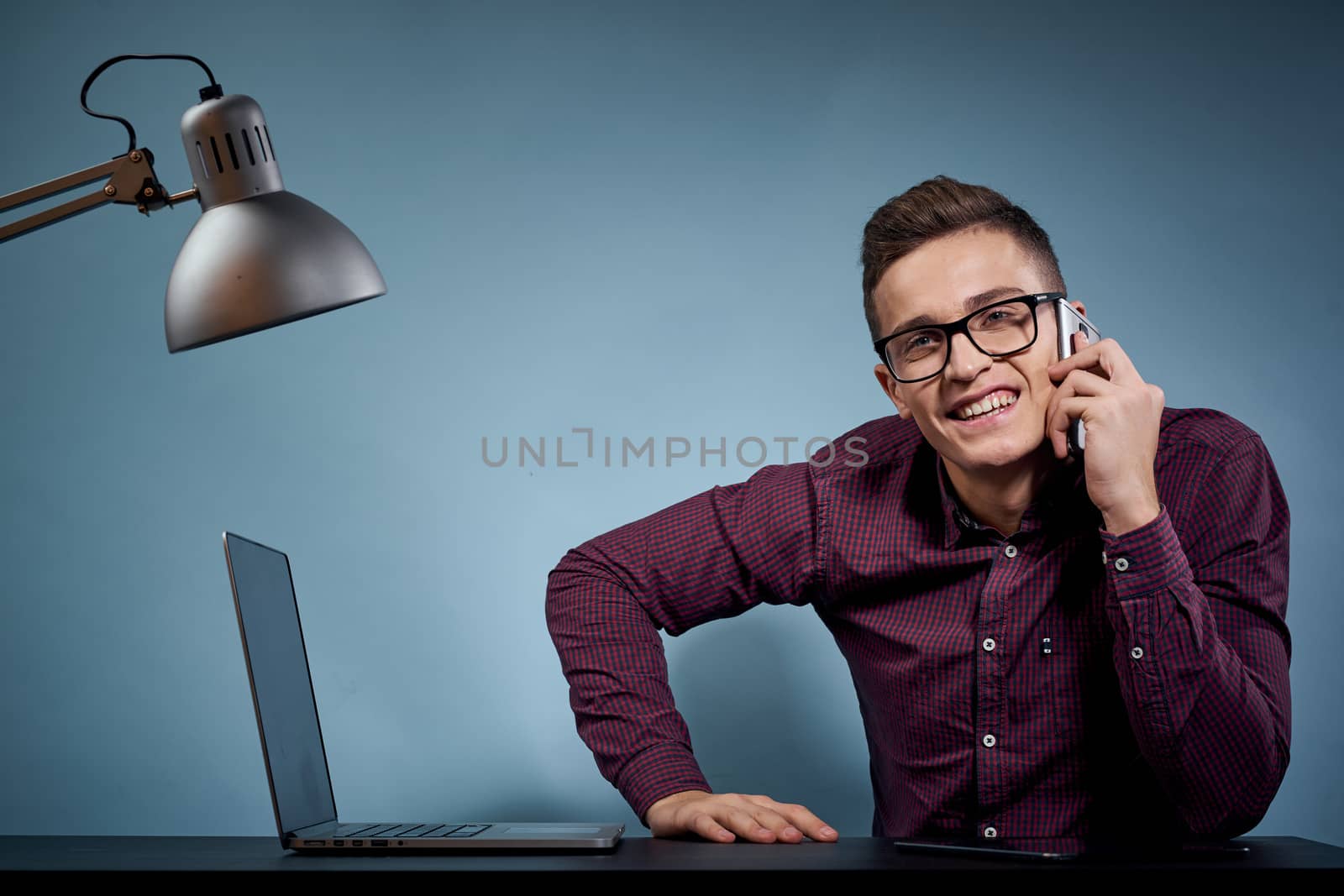 Business man talking on the phone in the office open laptop manager communication model. High quality photo