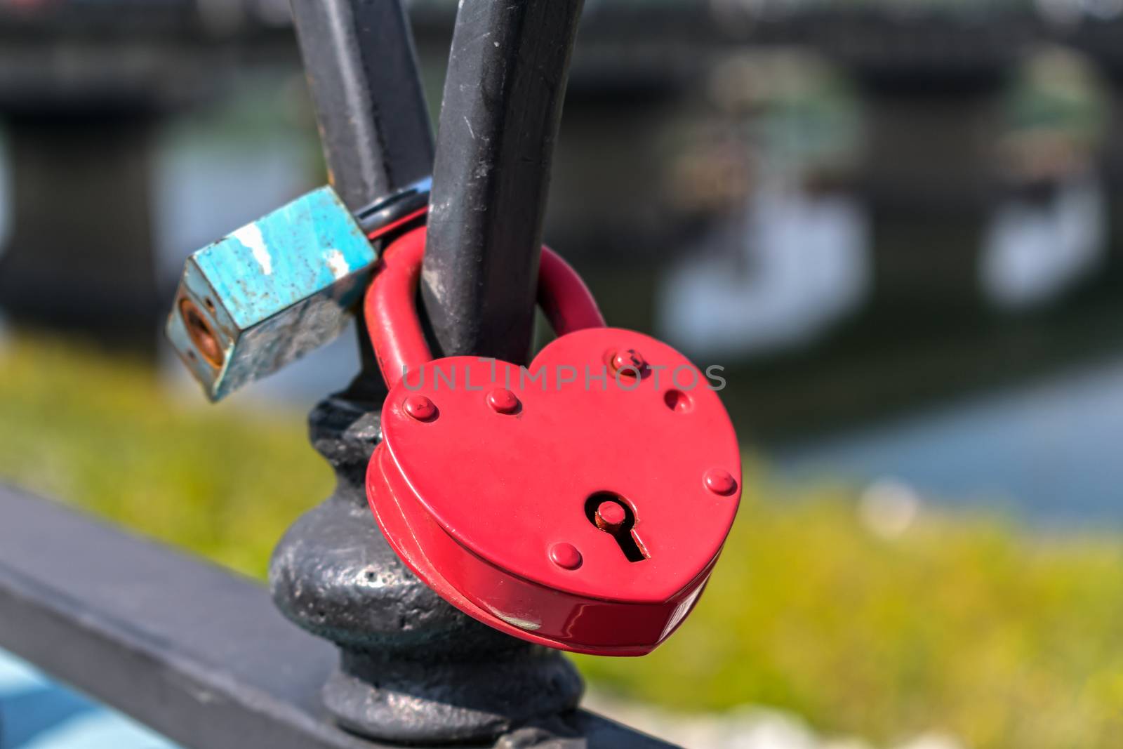 Padlocks symbolizing strong marriage and love attached to the railing of the bridge