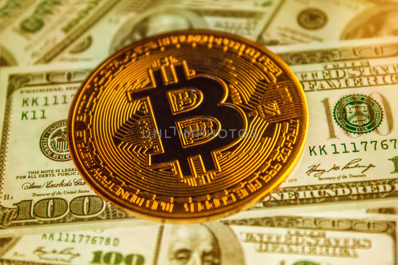 Bitcoin coin against the background of us dollars. A lot of American money dollars and gold bitcoin. Background of money and cryptocurrency.Money background. Screen full of dollars close up.