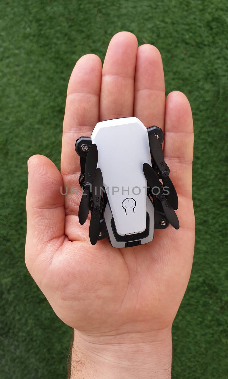 Hand holding micro foldable pocket drone gadget
