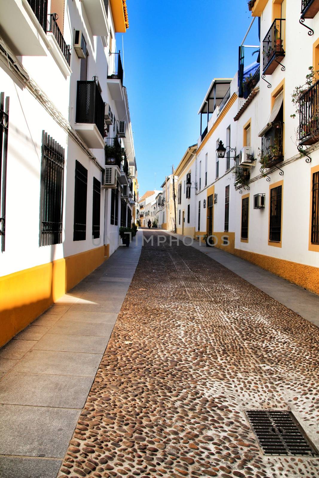 Narrow streets and majestic facades in Cordoba city, Spain.