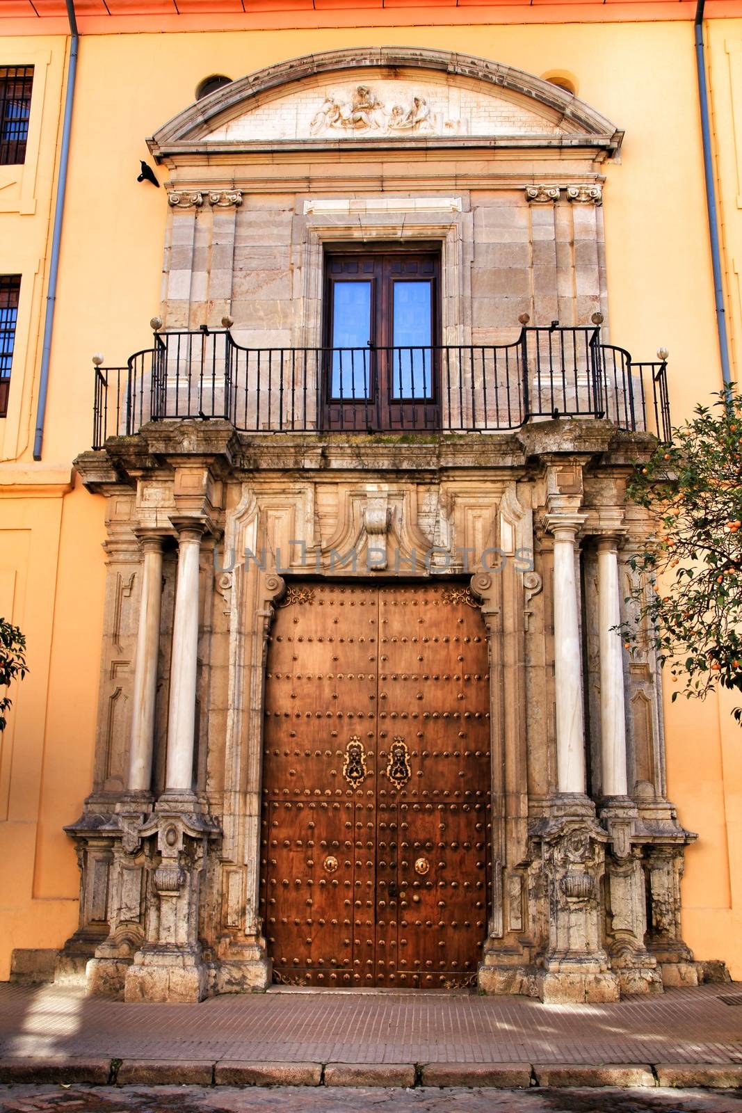 Colorful and majestic old house facade in Cordoba, Spain in a sunny day of winter
