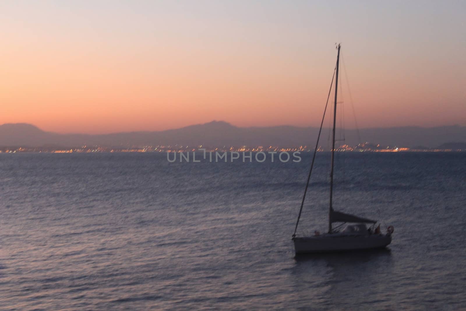 Sailboat anchored in the island of Tabarca, Alicante, at dusk in summer