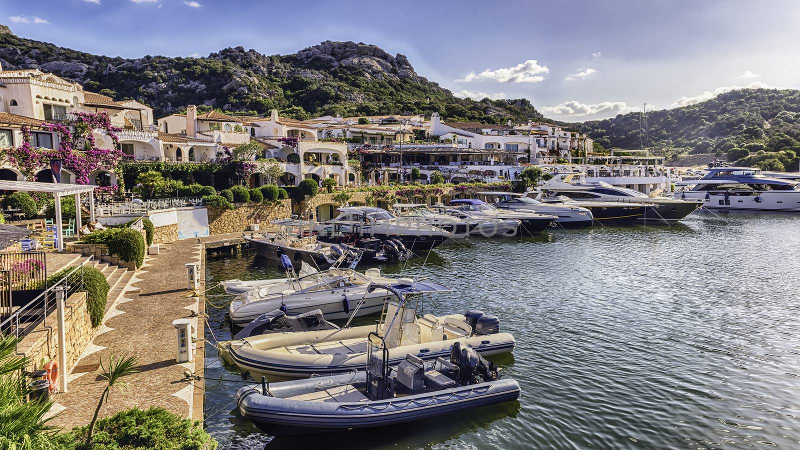 View of the harbor with luxury yachts of Poltu Quatu, Sardinia, Italy. This picturesque town is a real gem in Costa Smeralda and a luxury yacht magnet and billionaires' playground