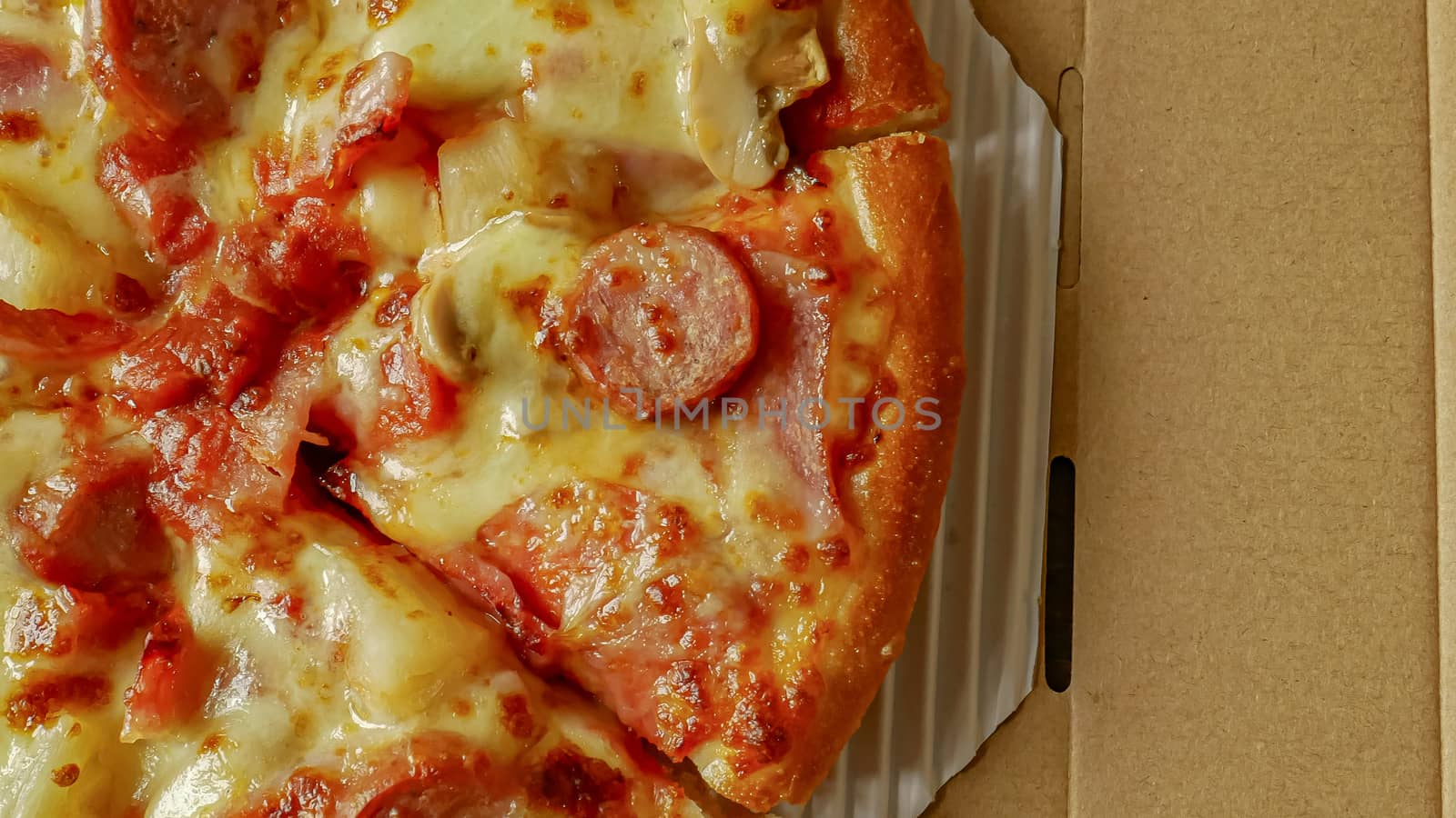 The pizza in paper box  close up image for food content.