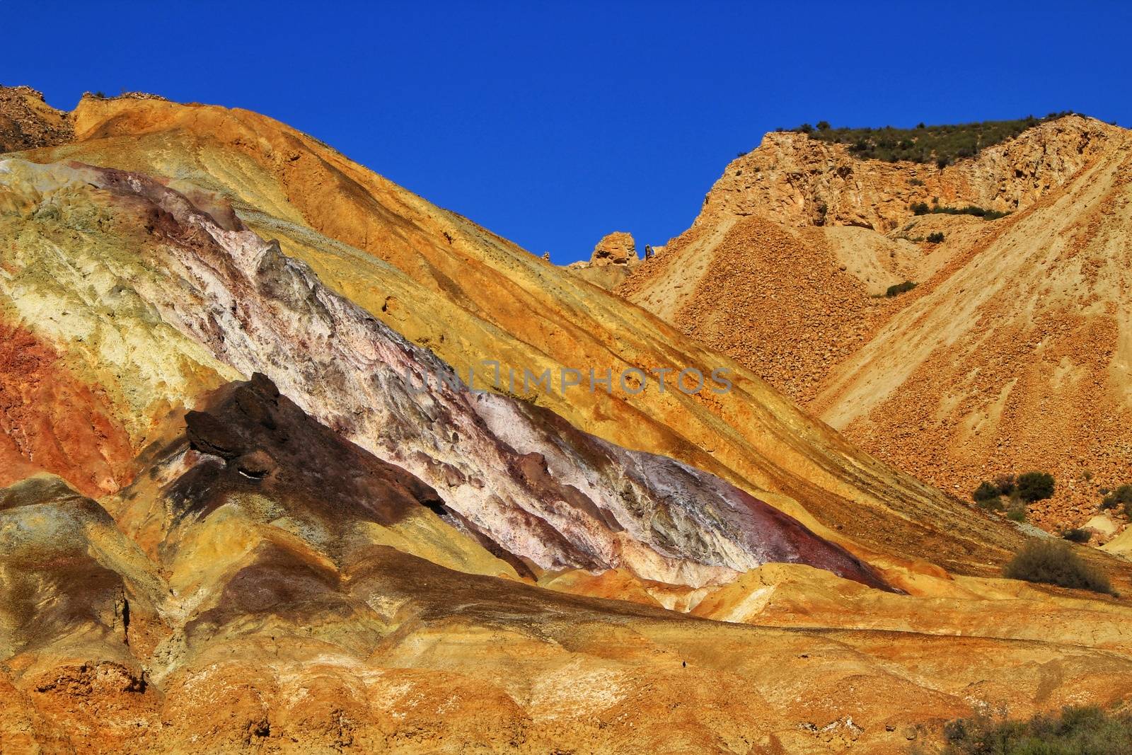 Beautiful and colorful mineral streaks and sediments in a old abandoned quarry